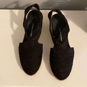 Black espadrilles with black embroidered detail on toe and black elastic